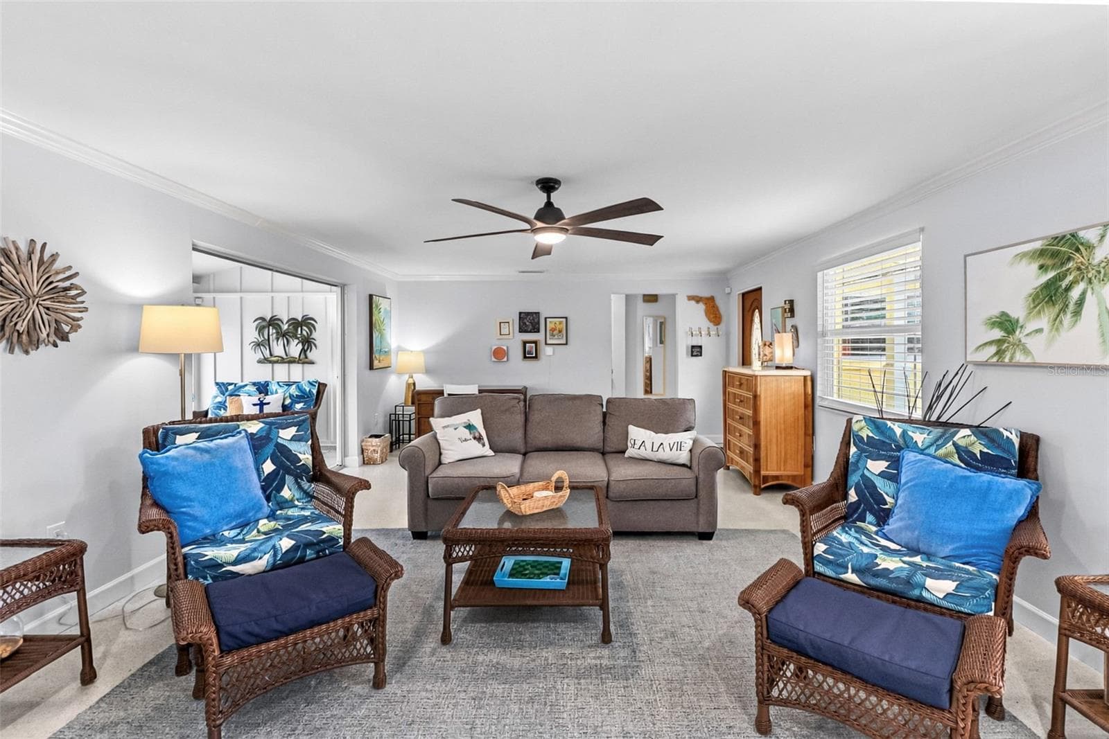 Living room with coastal seating and terrazzo floors. - 912 CHURCH ST, VENICE