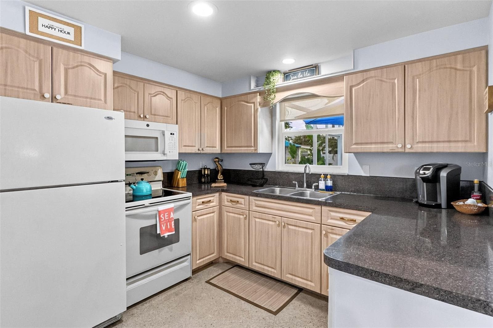 Kitchen with wood-tone cabinetry and ample counter space - 912 CHURCH ST, VENICE