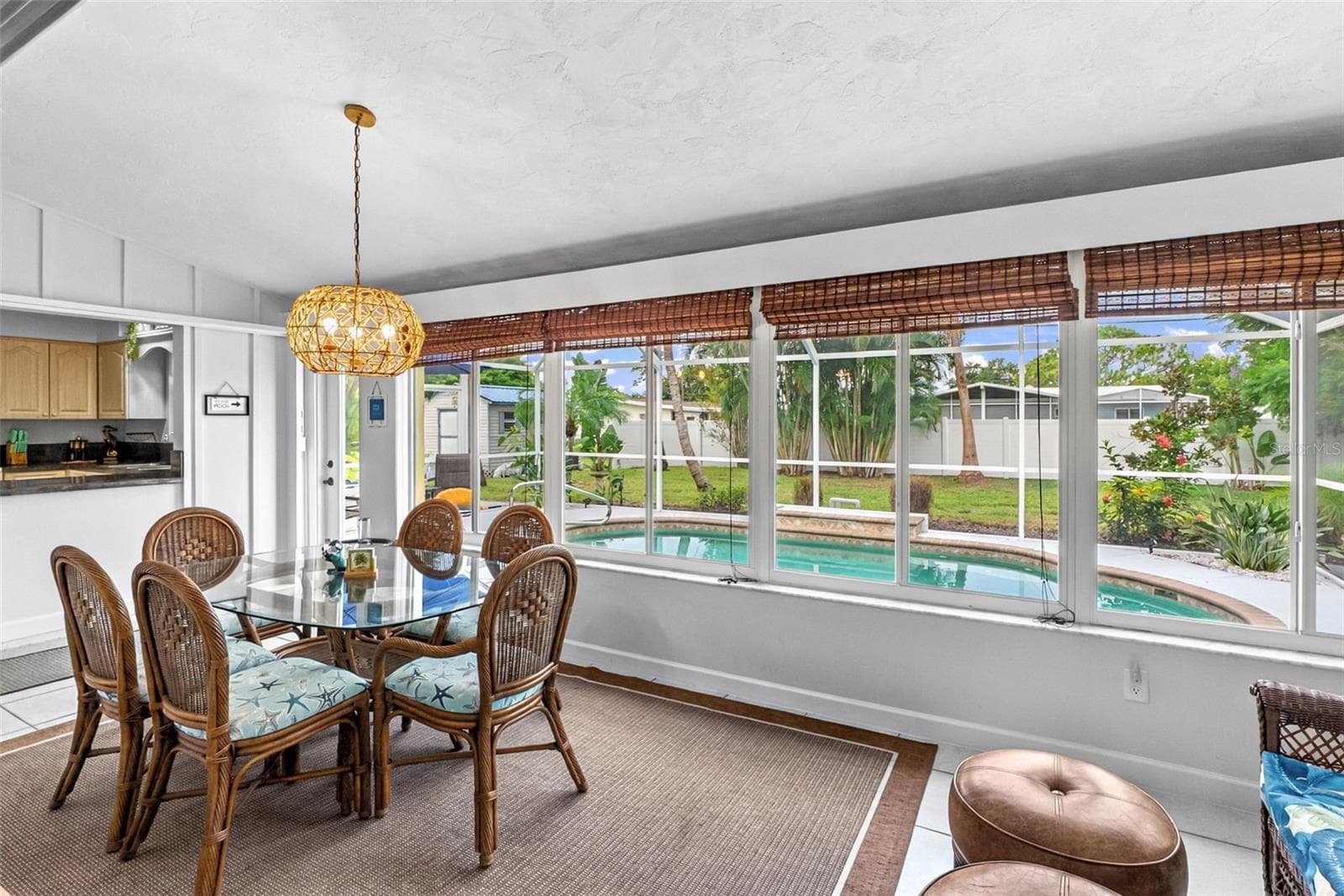Florida room dining area with pool views. - 912 CHURCH ST, VENICE