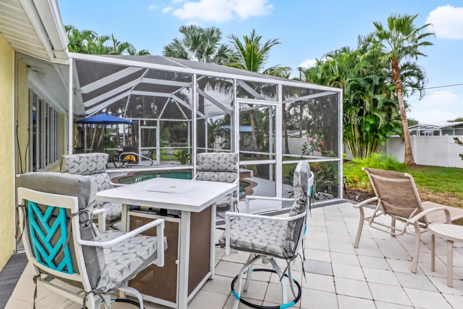 Outdoor dining patio beyond the screened pool enclosure. - 912 CHURCH ST, VENICE