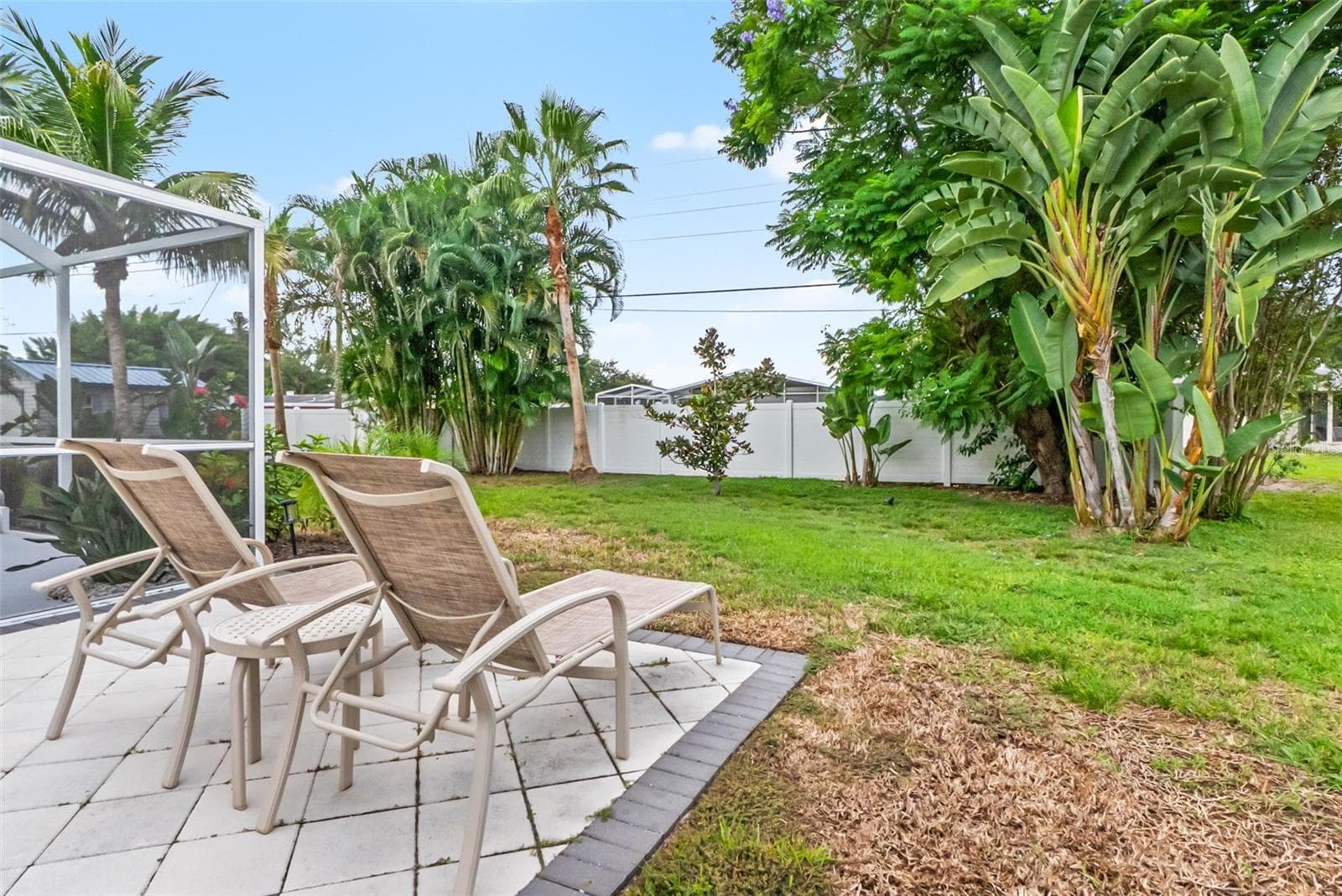 Open patio with lounge seating overlooking the backyard. - 912 CHURCH ST, VENICE