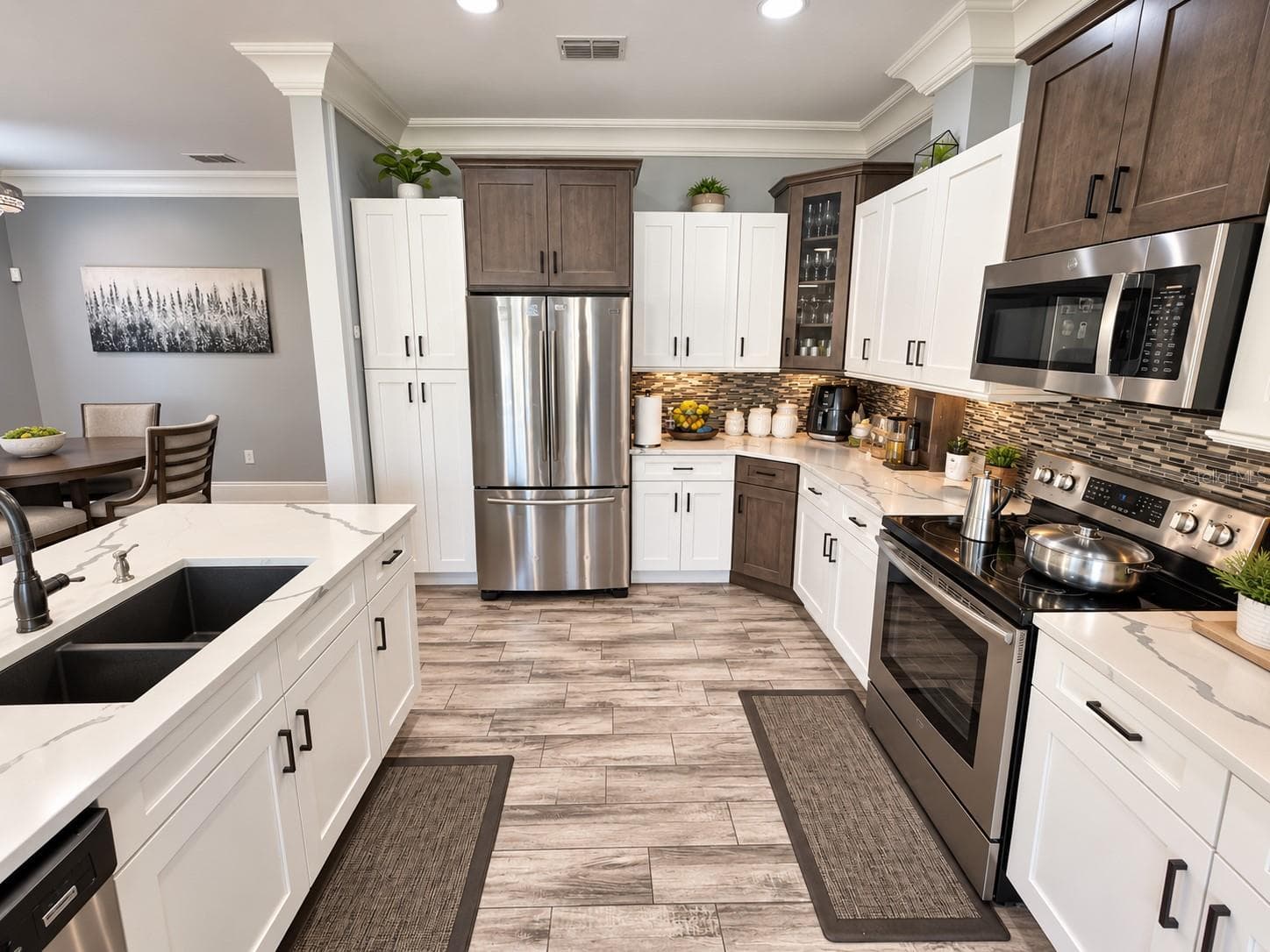 Kitchen with stainless steel appliances and generous counter space. - 3998 PEMBERLY PINES CIR, ST CLOUD