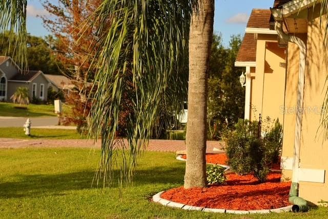 Front view shows you a portion of the large front patio from the fence. - 4030 SANTA BARBARA RD, KISSIMMEE