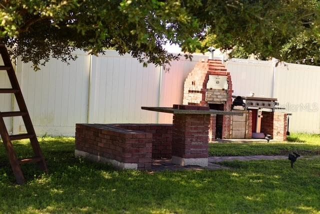 Rear Patio BBQ Area, noticed fenced lot - 4030 SANTA BARBARA RD, KISSIMMEE