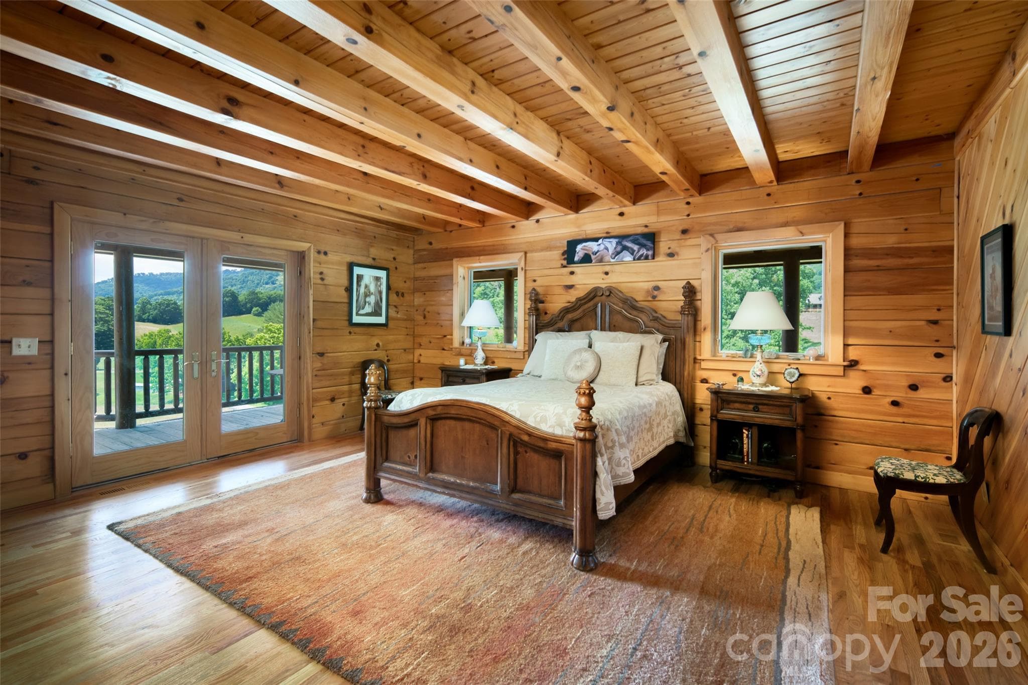 Primary bedroom on main level with en-suite full bathroom. - 316 Stevenson Cove Road, Waynesville
