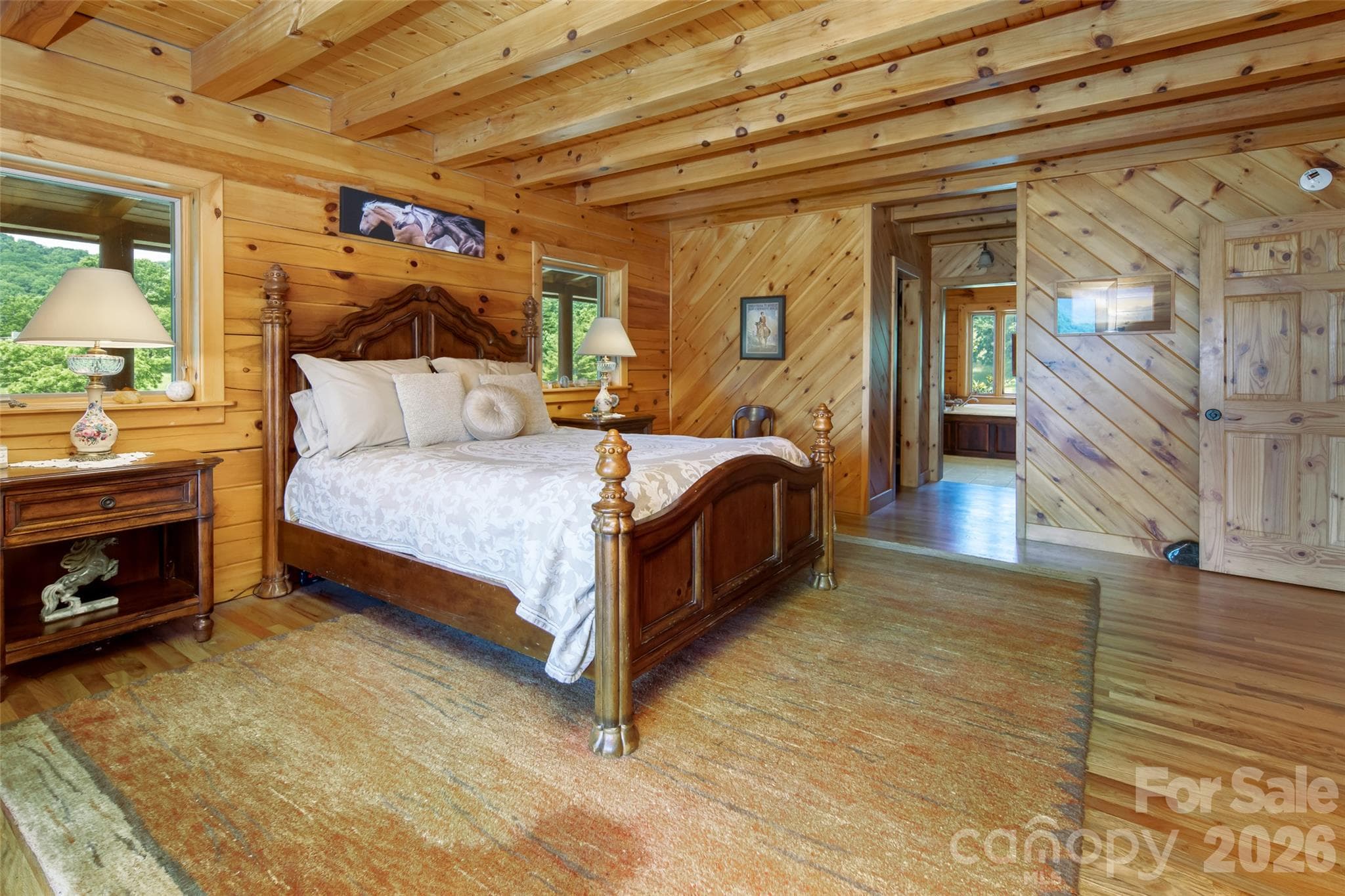 Primary bedroom on main level with en-suite full bathroom with garden tub. - 316 Stevenson Cove Road, Waynesville