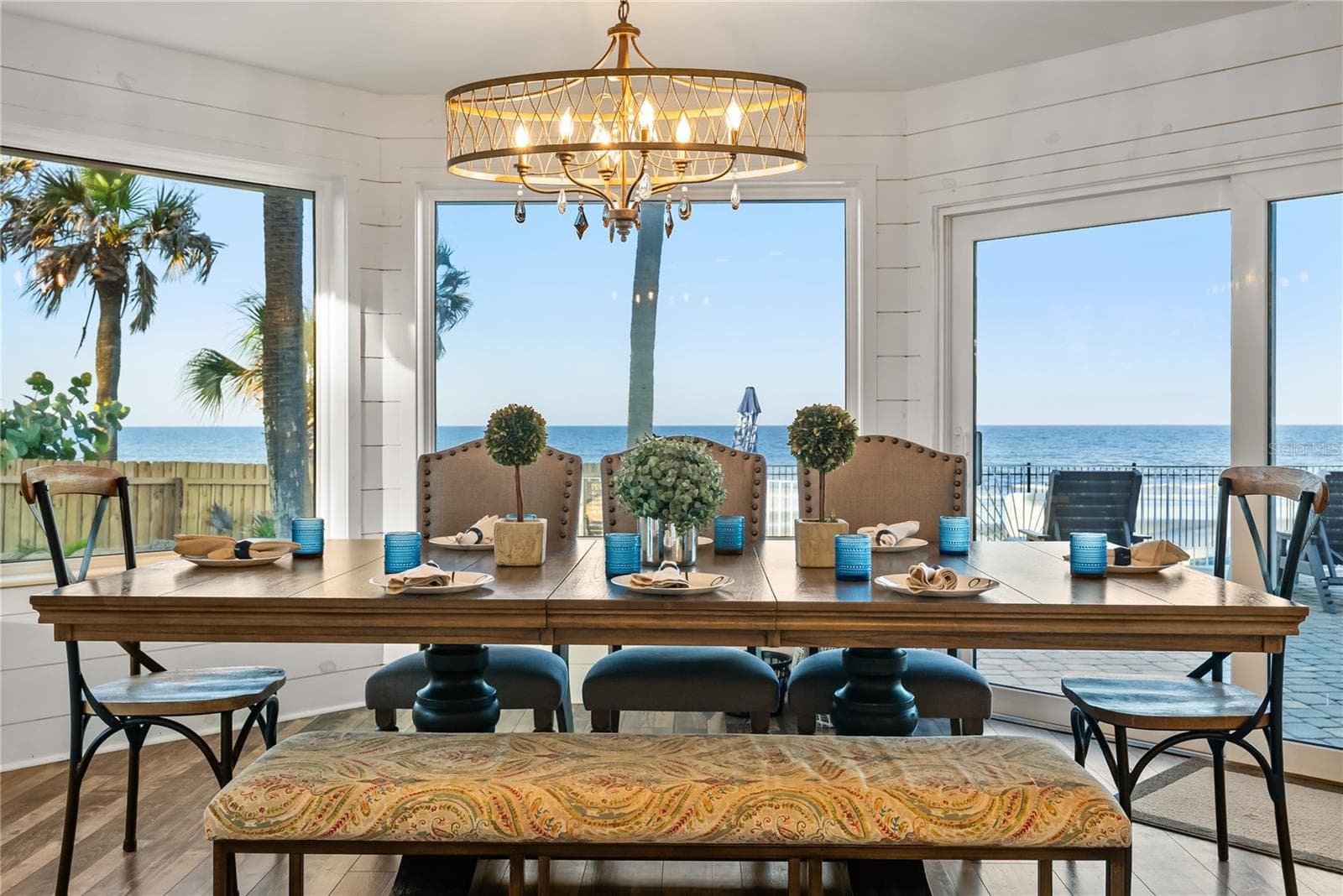 Spacious eat-in kitchen with stainless steel appliances, quartz countertops, breakfast bar seating, and beautiful ocean views—an inviting setting for casual meals and gathering. - 2707 S ATLANTIC AVE, DAYTONA BEACH SHORES