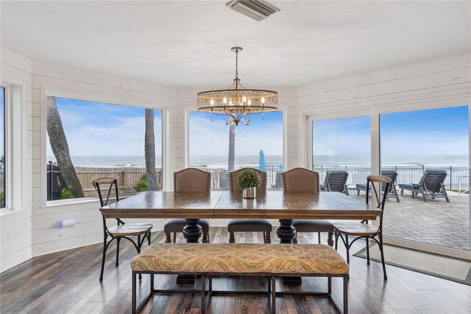 Spacious eat-in kitchen with stainless steel appliances, quartz countertops, breakfast bar seating, and beautiful ocean views—an inviting setting for casual meals and gathering. - 2707 S ATLANTIC AVE, DAYTONA BEACH SHORES
