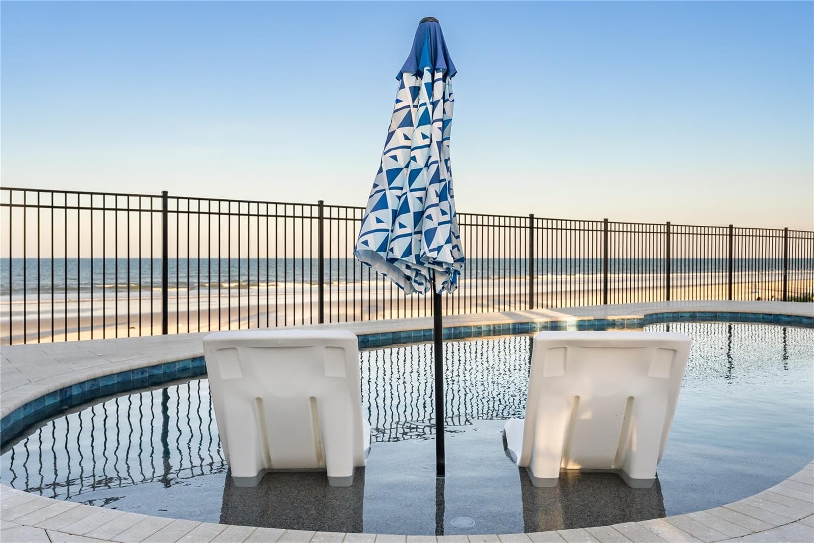 new poolNew oceanfront pool installed in 2024, featuring heating, a sun shelf, bubblers, and a 7-foot-deep end, with expansive patio space and panoramic Atlantic views. - 2707 S ATLANTIC AVE, DAYTONA BEACH SHORES