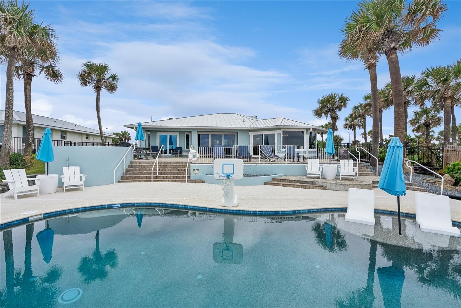 New oceanfront pool installed in 2024, featuring heating, a sun shelf, bubblers, and a 7-foot-deep end, with expansive patio space and panoramic Atlantic views. - 2707 S ATLANTIC AVE, DAYTONA BEACH SHORES