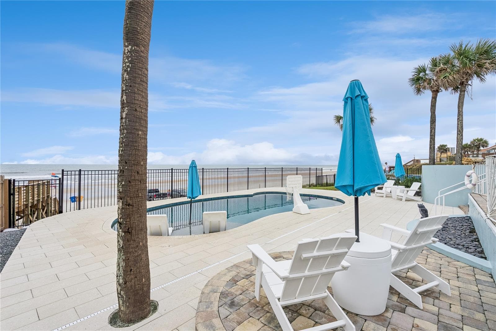 New oceanfront pool installed in 2024, featuring heating, a sun shelf, bubblers, and a 7-foot-deep end, with expansive patio space and panoramic Atlantic views. - 2707 S ATLANTIC AVE, DAYTONA BEACH SHORES