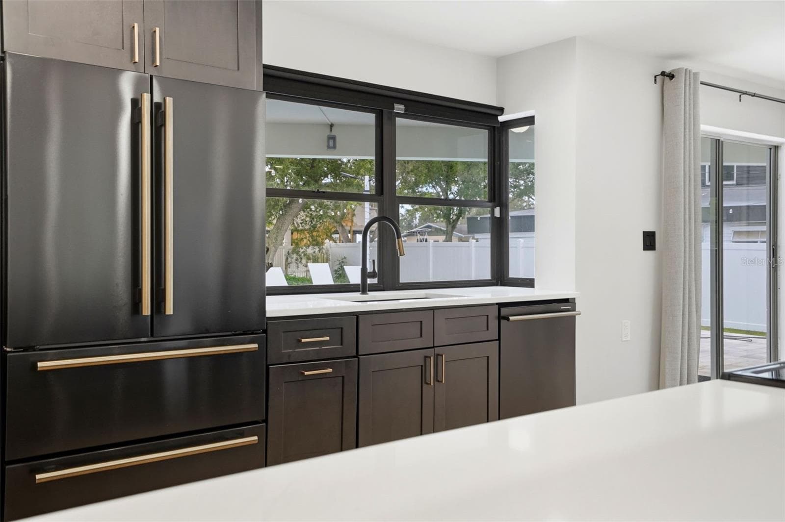 Beautiful view of Pool from Kitchen Sink & Pass-through Window - 330 PATICA RD NE, ST PETERSBURG