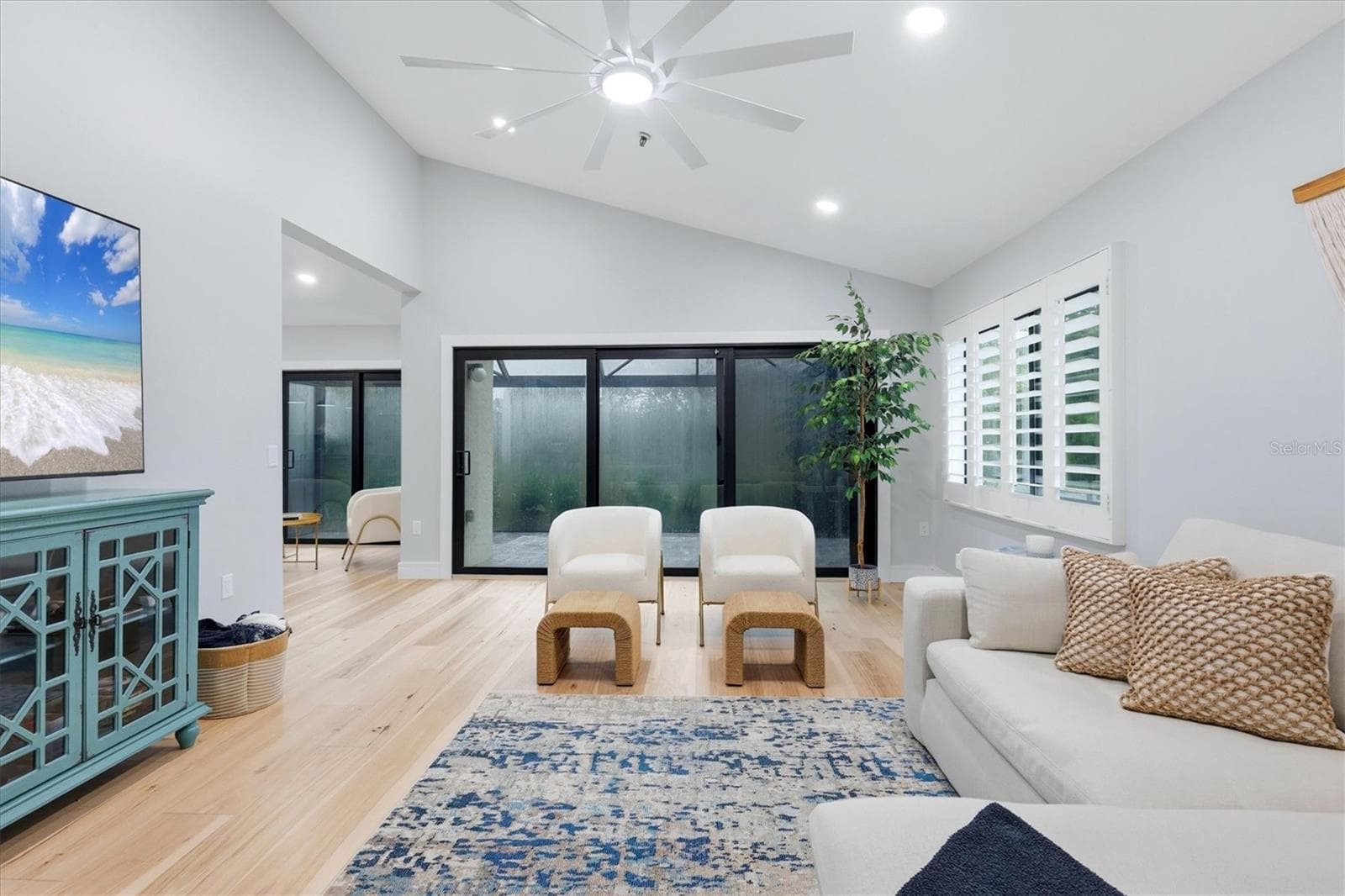 Living room opens to lanai with new screened enclosure and new stone pavers - 2141 HARBOURSIDE DR #1203, LONGBOAT KEY