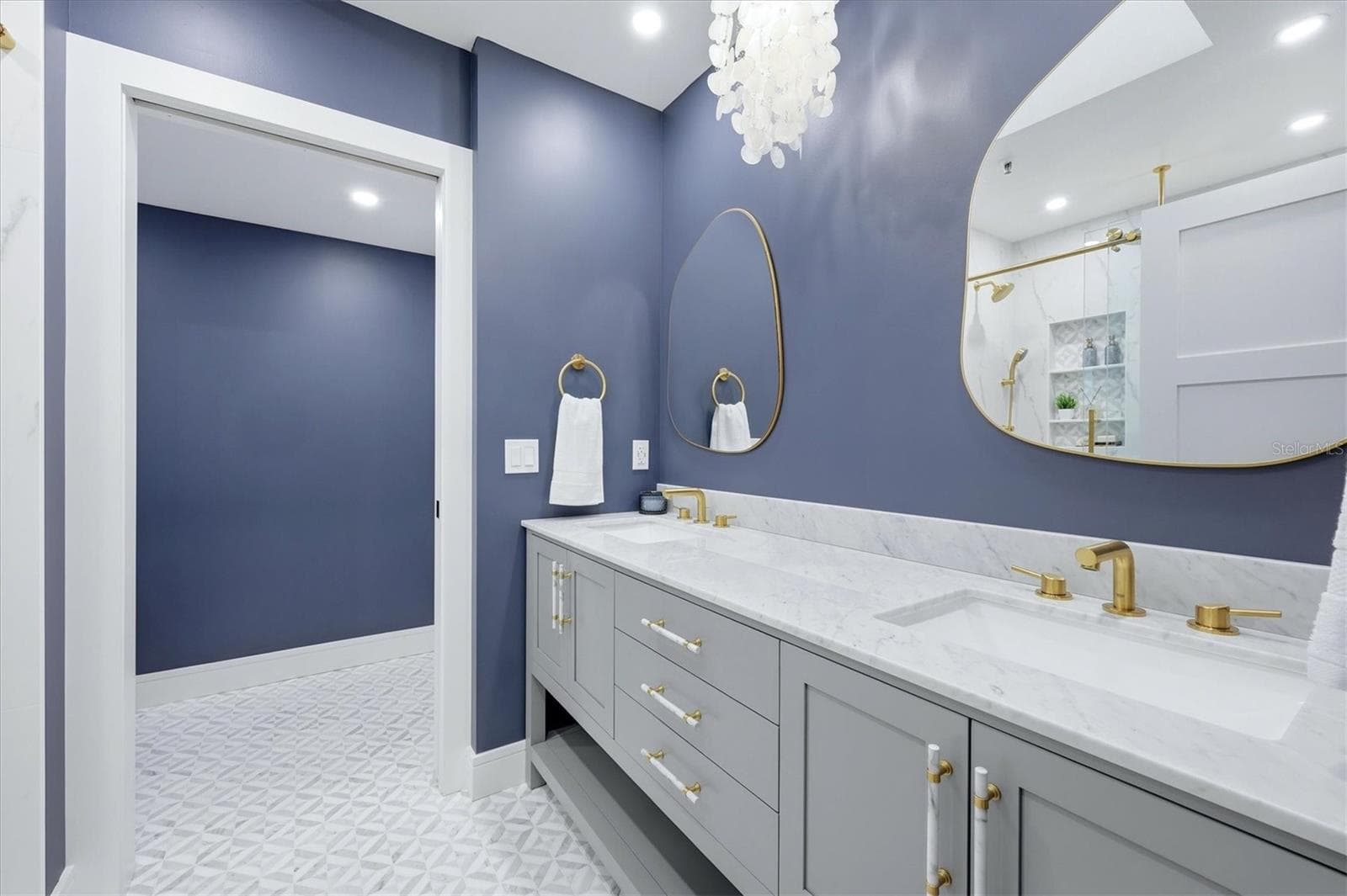 Primary Bathroom with Double Sinks and Carerra Marble vanity top, water closet with linen storage - 2141 HARBOURSIDE DR #1203, LONGBOAT KEY