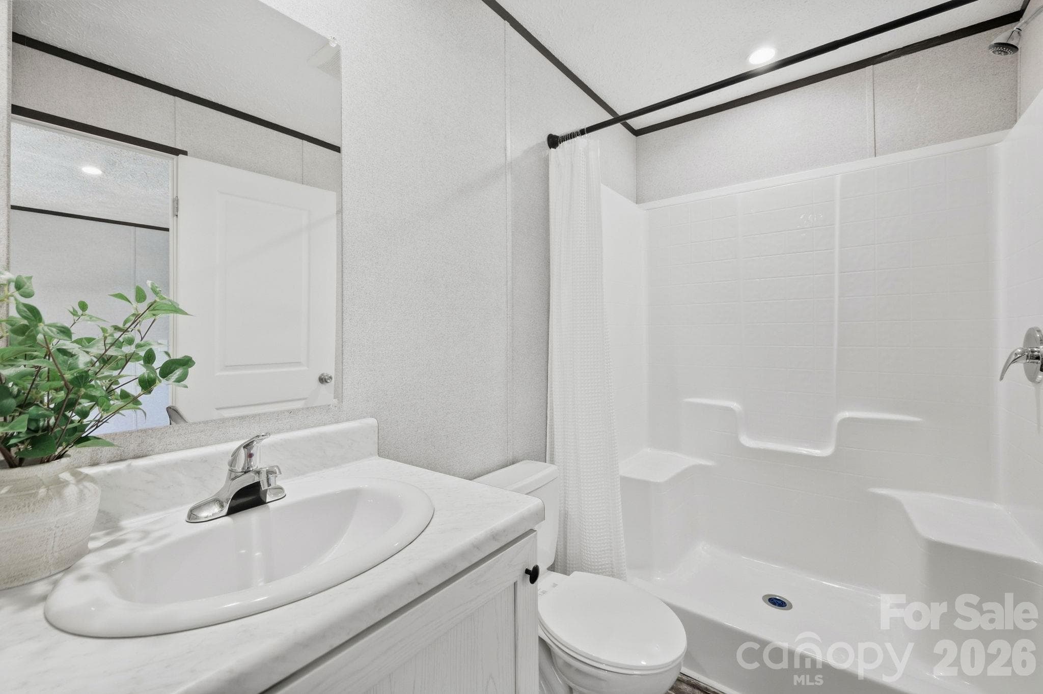 Primary bathroom offers a roomy shower. - 85 Trent Road, Brevard