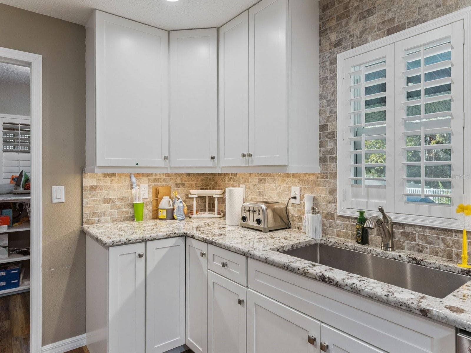 Kitchen with stone-look backsplash - SPRING LAKE MANOR, FRUITLAND PARK