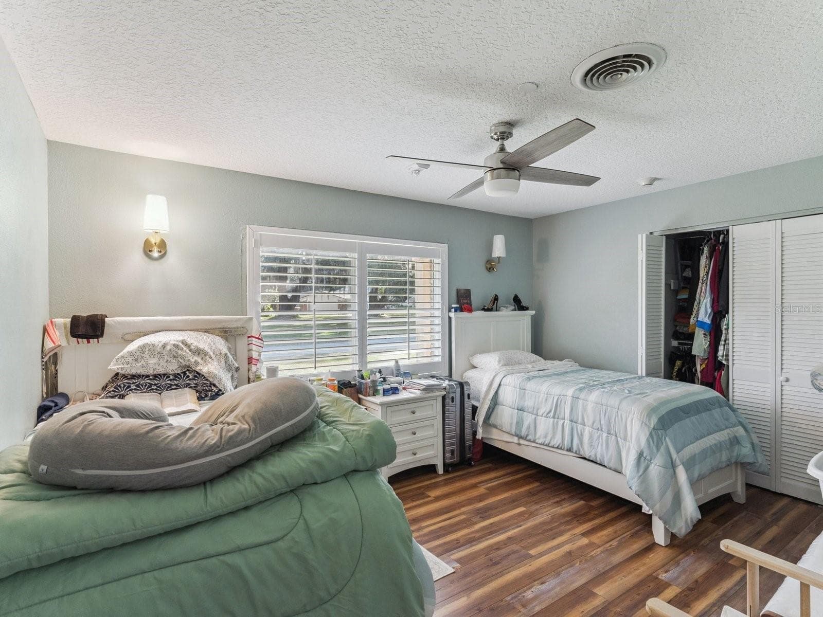 Bedroom with ceiling fan and wall sconces - SPRING LAKE MANOR, FRUITLAND PARK