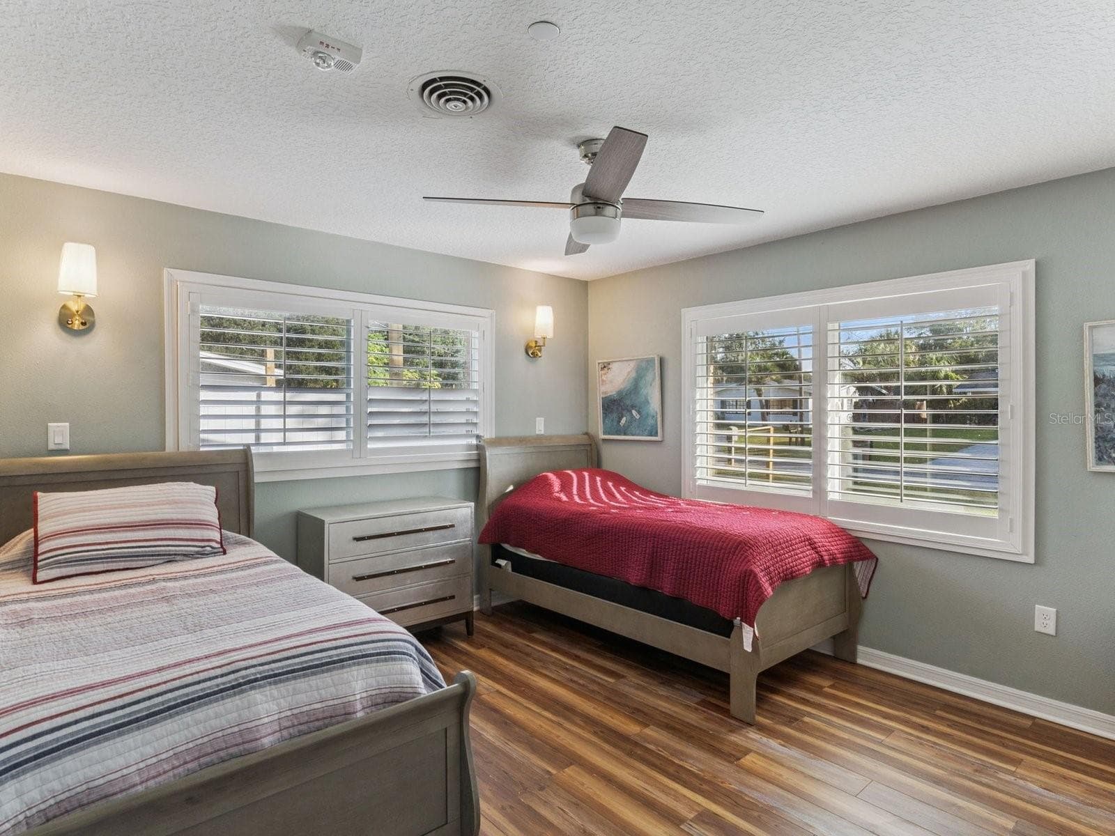 Bedroom with ceiling fan and wall sconces - SPRING LAKE MANOR, FRUITLAND PARK