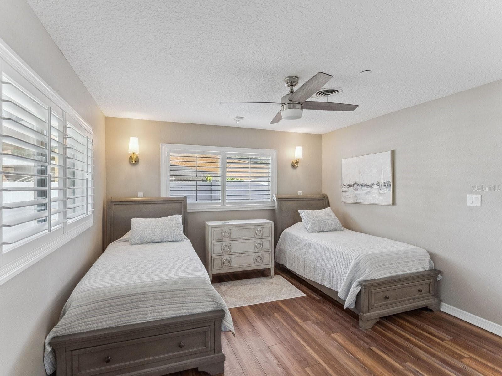 Bedroom with ceiling fan and wall sconces - SPRING LAKE MANOR, FRUITLAND PARK