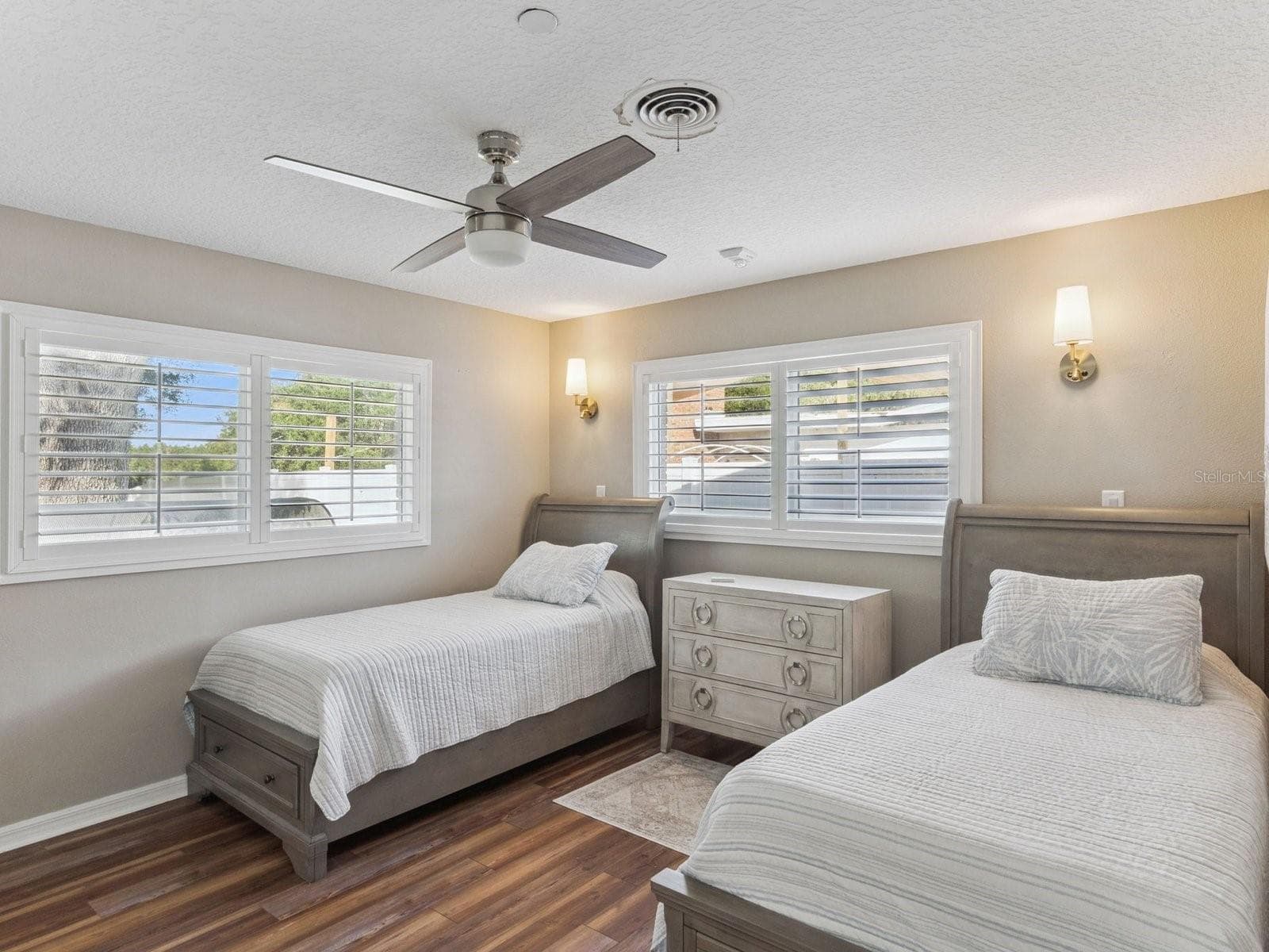 Bedroom with ceiling fan and wall sconces - SPRING LAKE MANOR, FRUITLAND PARK