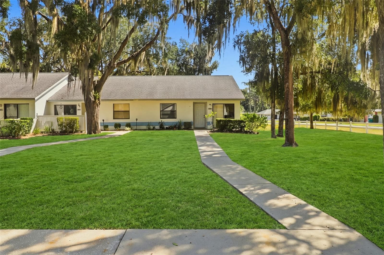 front view of townhouse and front yard with walk up sidewalk from parking spot - 480 LANDING BLVD, INVERNESS
