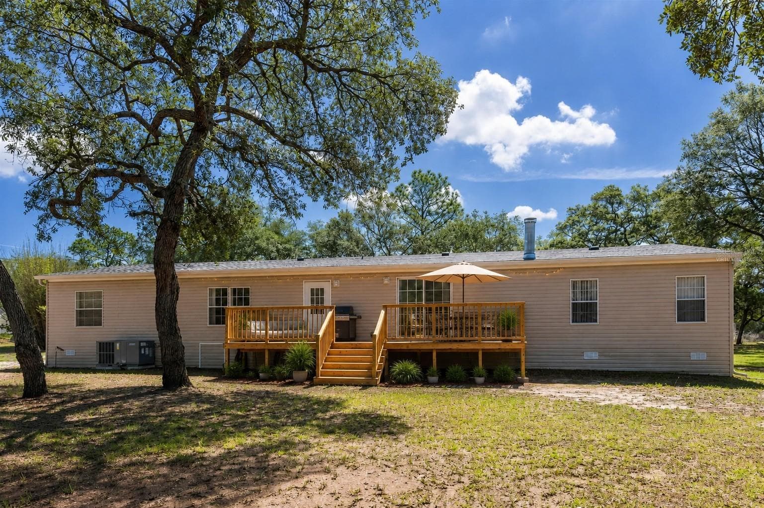 Virtually staged porch deck for grilling and relaxing. - 14221 HURRICANE DR, WEEKI WACHEE