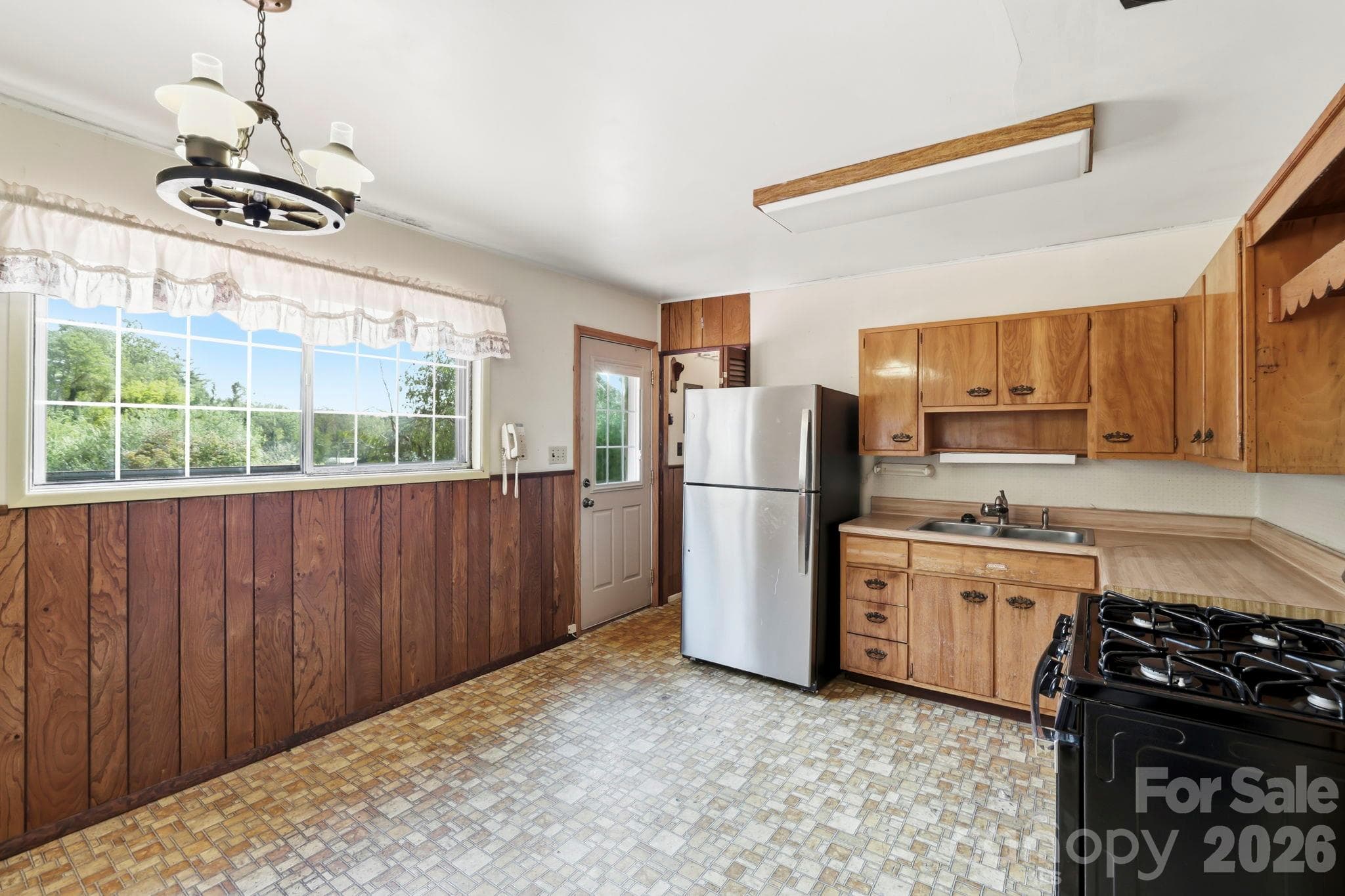 Kitchen, looking towards Living Room. Door on left is to the back deck. Door straight ahead is to the walk in pantry - 648 Crystal Drive - 648 Crystal Drive, Hendersonville