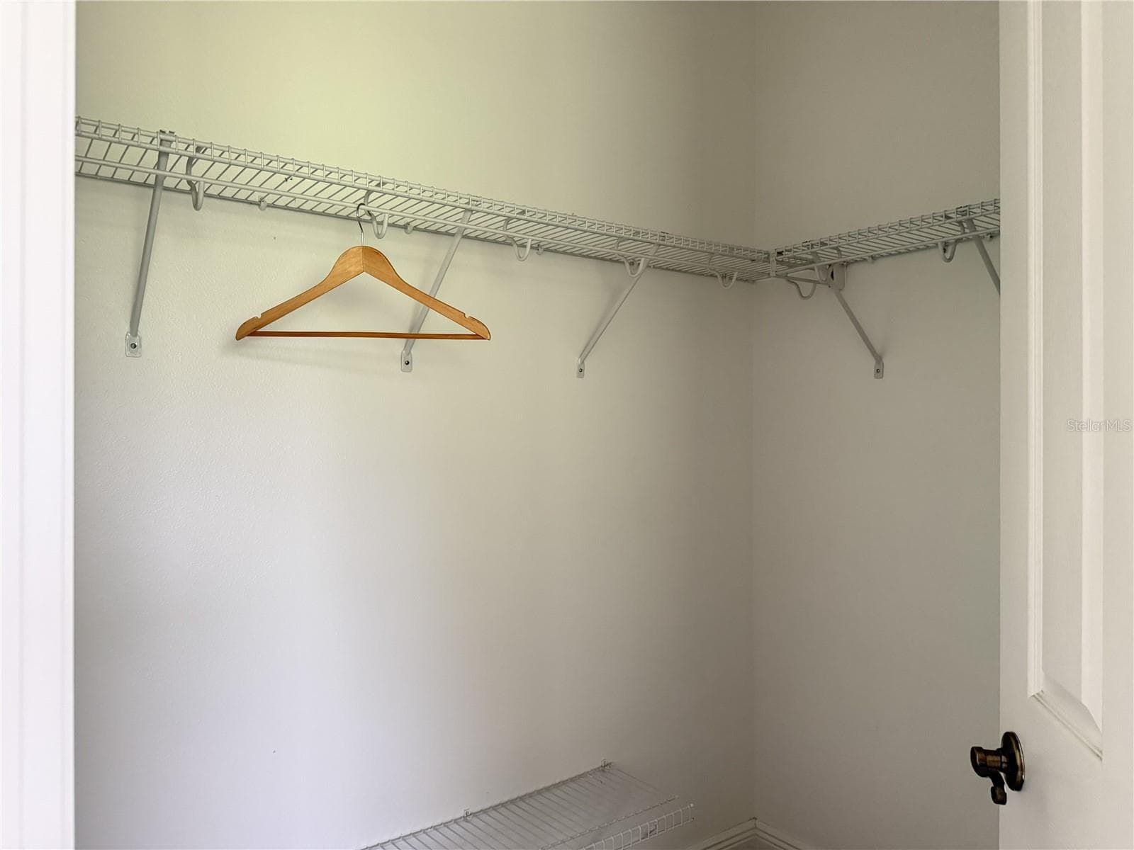 Primary walk-in closet #1 with wire shelving. - 39539 HARBOR HILLS BLVD, LADY LAKE