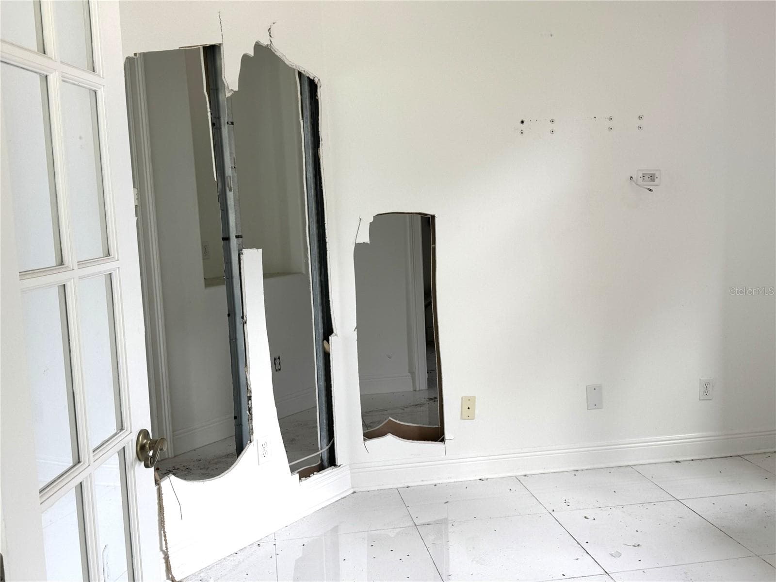 Study/den with missing drywall and exposed wall framing requiring restoration. - 39539 HARBOR HILLS BLVD, LADY LAKE