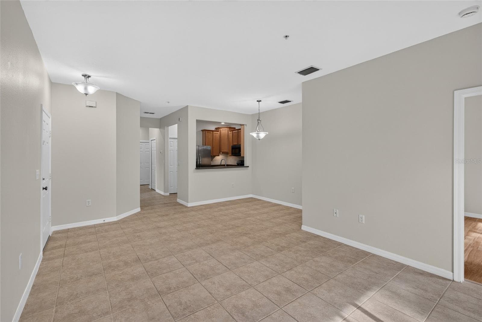 Open living and dining area, tile throughout - 3707 PARKRIDGE CIR #7-106, SARASOTA