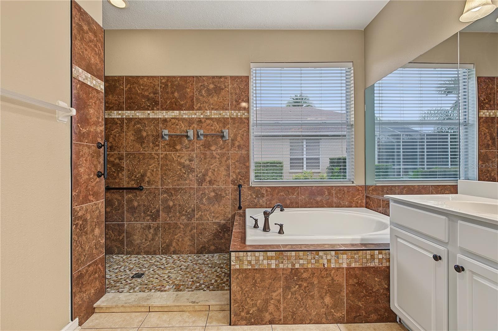 Master Bathroom, separate tub and shower, double vanities and a ceiling fan. - 8417 FENWICK AVE, TAMPA