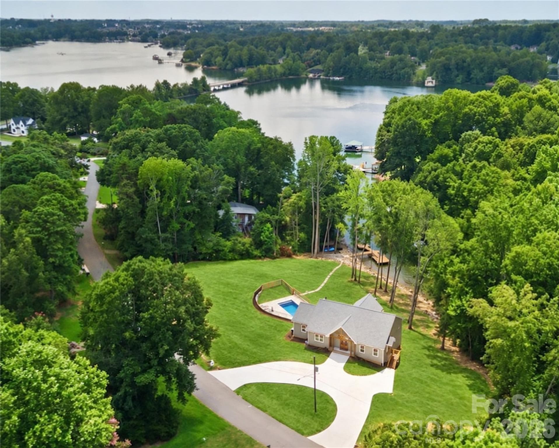 This private 1.36-acre estate is designed to maximize waterfront living, with spacious living areas, a private pool, generous lawn, and a waterside setting. - 143 Hideaway Lane, Mooresville