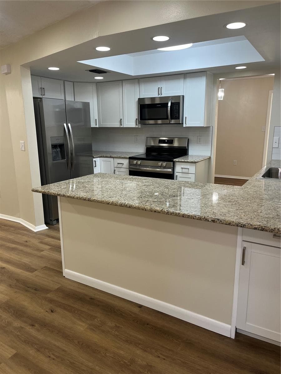 Light and Bright Completely Remodeled Kitchen with snack bar. - 2080 SUN TREE CIR N, CLEARWATER