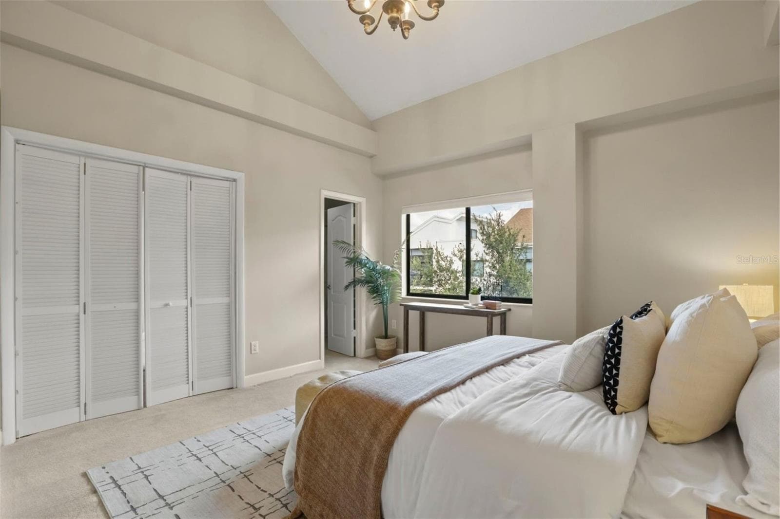 The primary suite with a large window overlooking the Park West garden and ornamental pond. - 300 CAROLINA AVE #402C, WINTER PARK