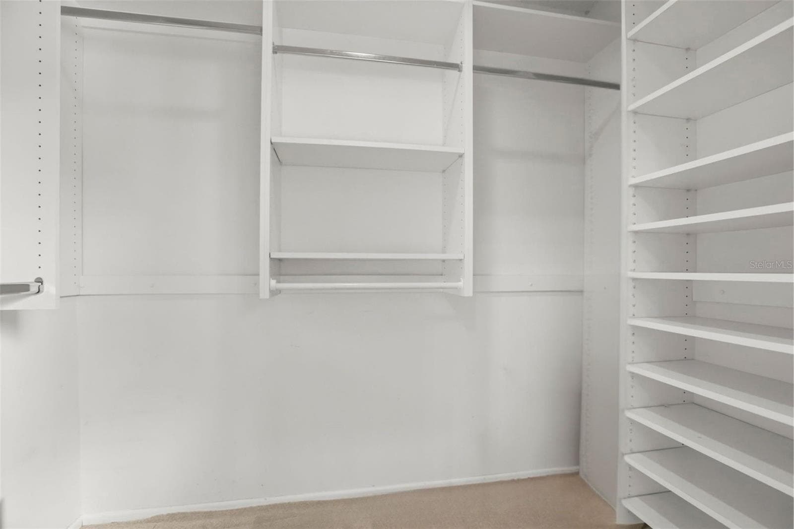 The primary suite features a vast walk-in closet enhanced with custom wall unit storage units. - 300 CAROLINA AVE #402C, WINTER PARK