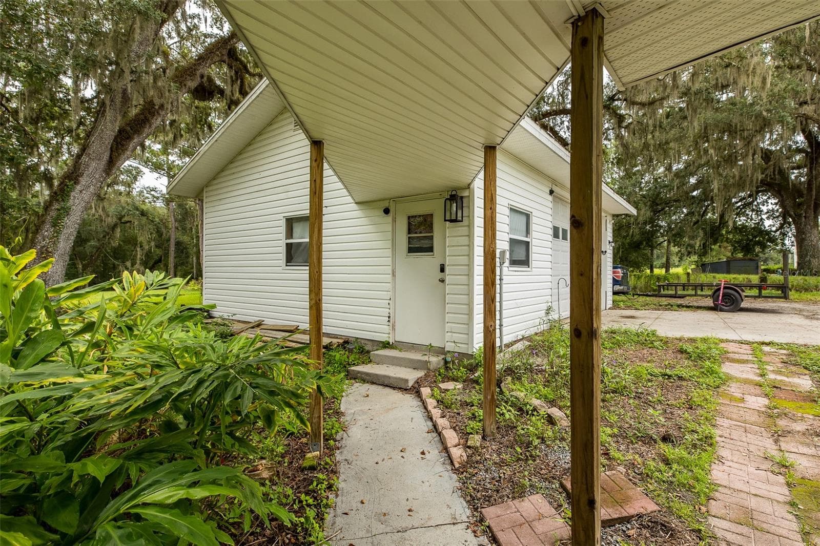 Walkway from house to detached Garage - 1205 S MAIN ST, BROOKSVILLE