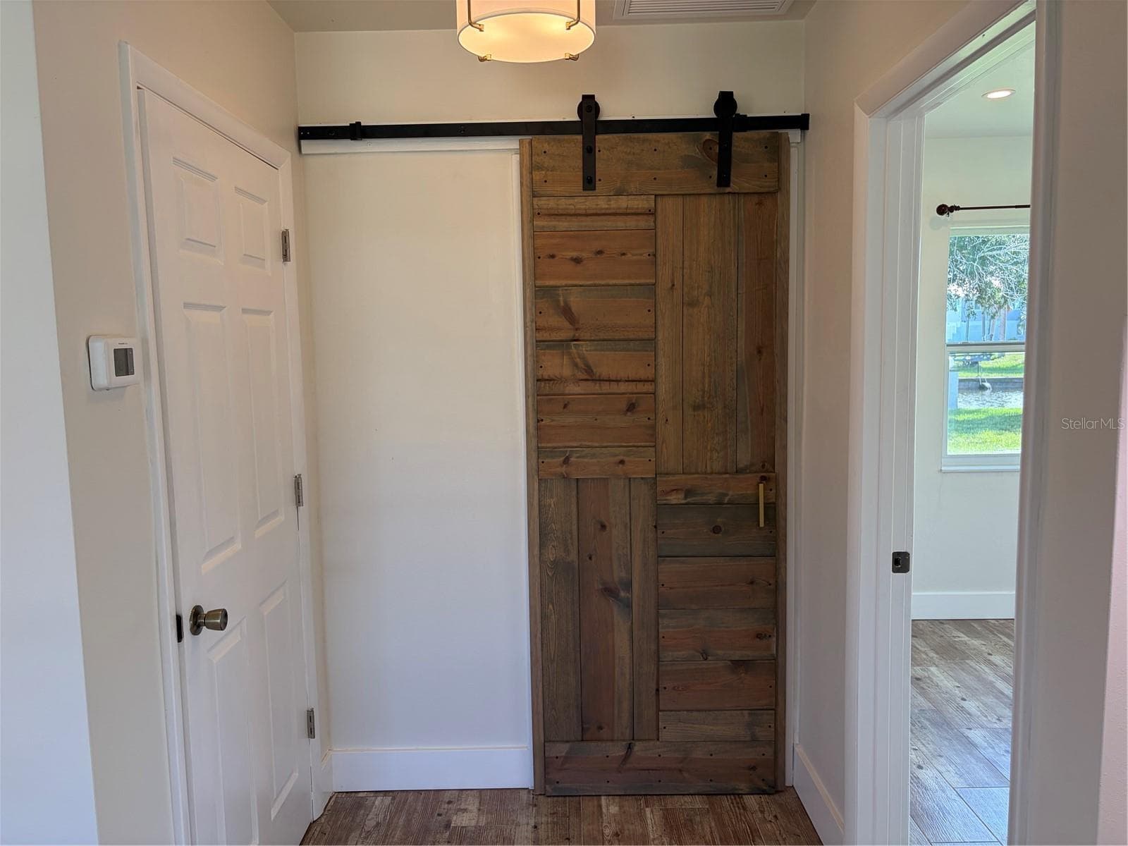 Primary bathroom barn door covering entrance - 10451 MARION ST, ENGLEWOOD