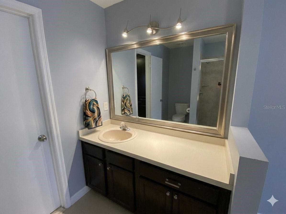 1st floor Primary Bedroom Make up or 2nd sink vanity Virtually Enhanced - 82 LAKEPOINTE CIR #82, KISSIMMEE