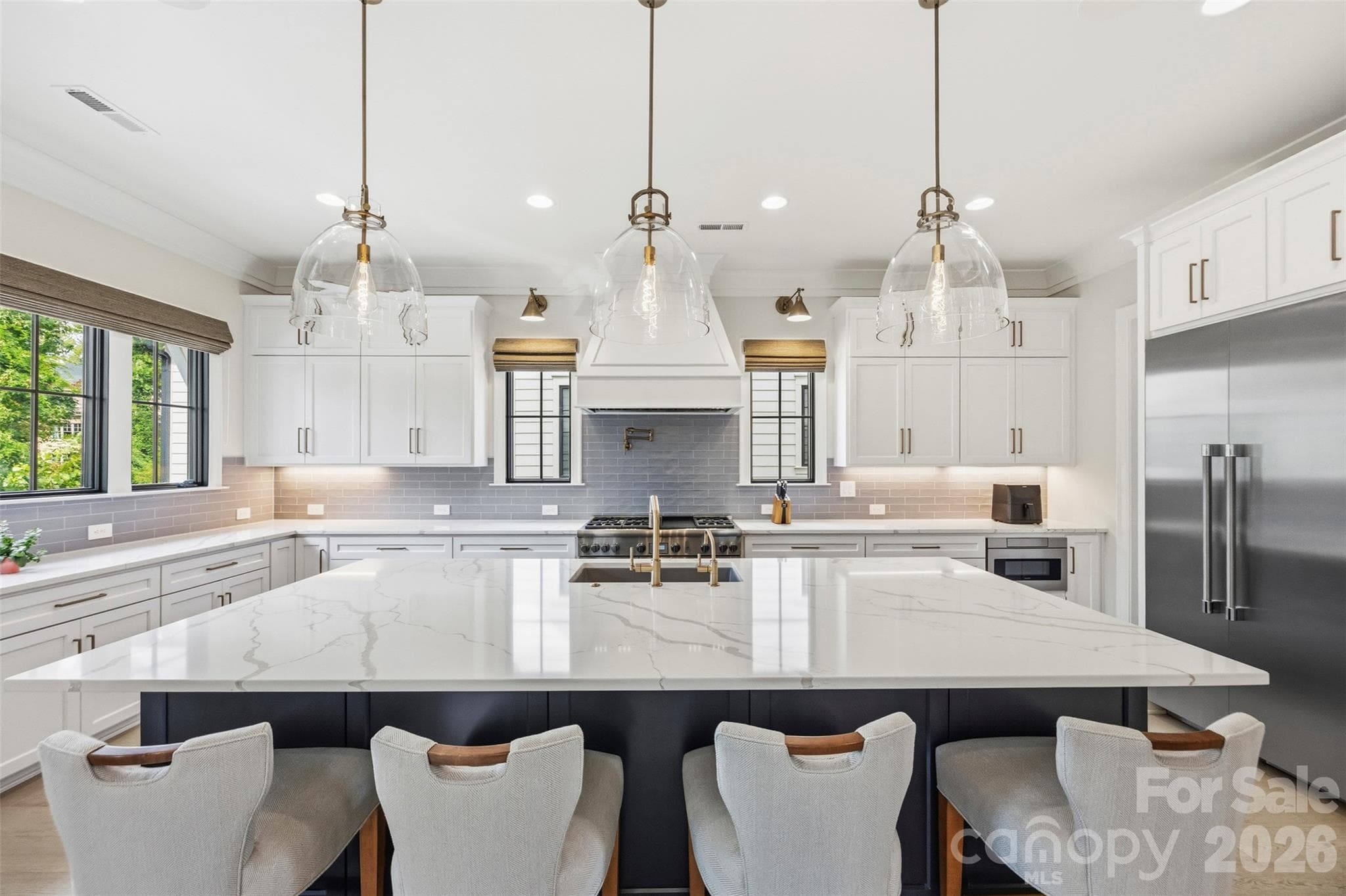 Thermador appliances including 6-burner gas stove, pot filler, and wine fridge. - 6222 Louis Patrick Lane, Charlotte