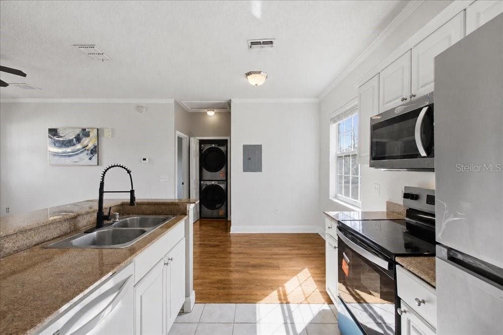 Appliances, counters, and laundry area. - 341 SOUTHERN PECAN CIR #202, WINTER GARDEN