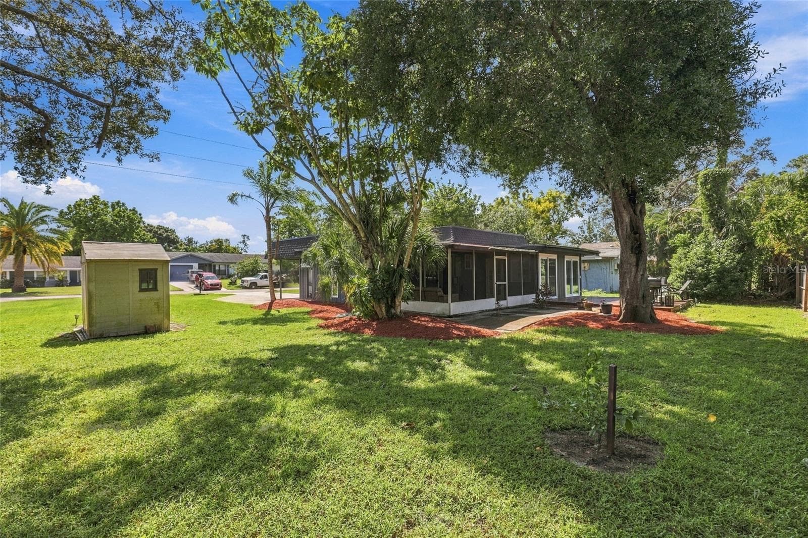 Detached Storage Shed on a Concrete Slab, Ideal for Lawn Equipment, Tools, and Outdoor Gear. Featuring a small lemon tree. - 2629 JAMAICA ST #1, SARASOTA
