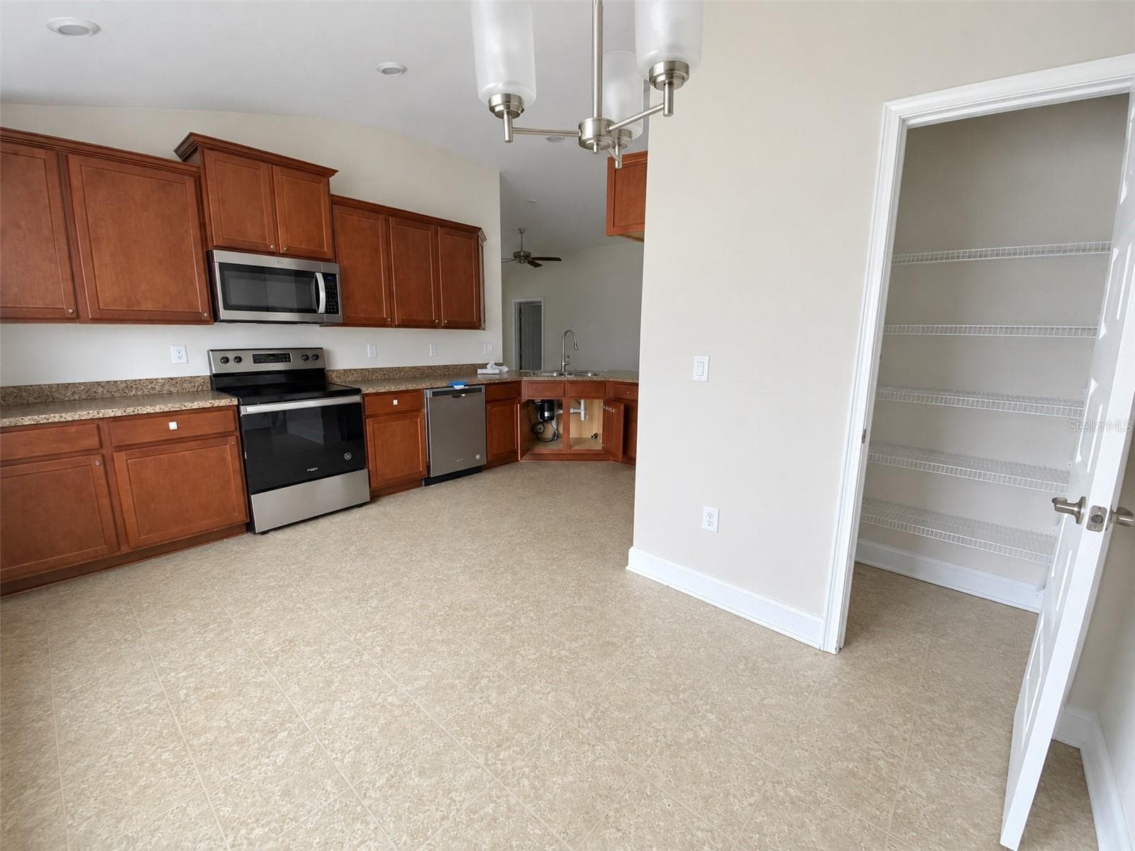 Kitchen Dining Area Looking Back Towards Cabinets. View of Pantry. - 2091 PECOS DR, POINCIANA