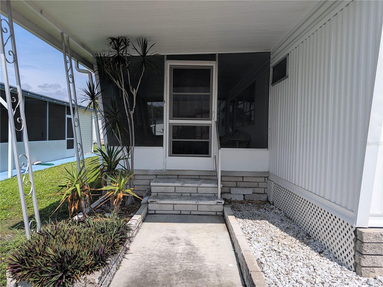 Entrance to large screened room. - 34517 ROSE DR N, PINELLAS PARK