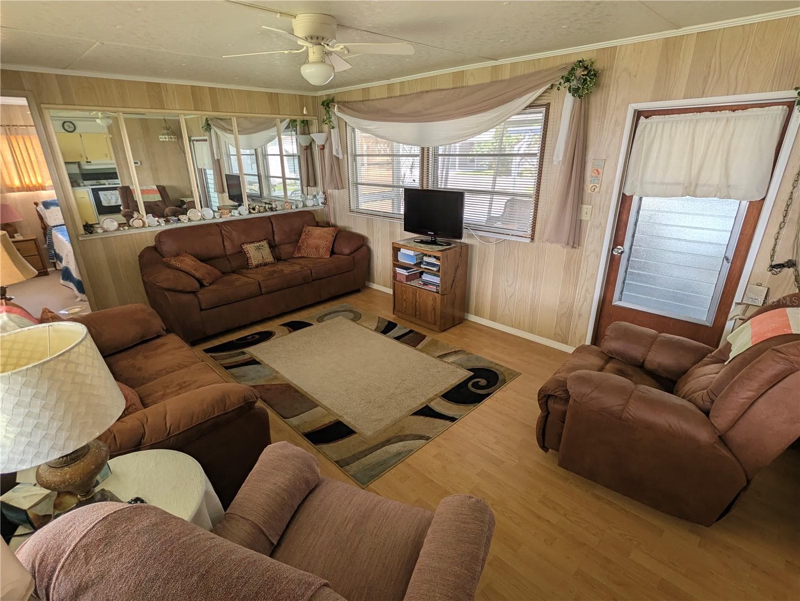 Living room, door leads to screen lanai - 34517 ROSE DR N, PINELLAS PARK