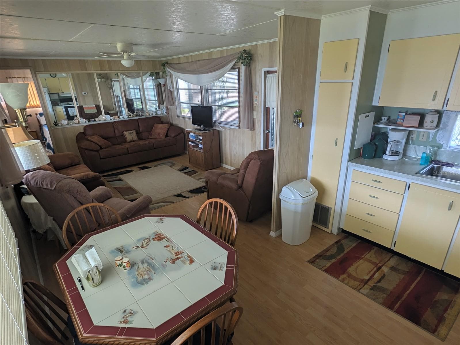 Dining room and kitchen combination. - 34517 ROSE DR N, PINELLAS PARK