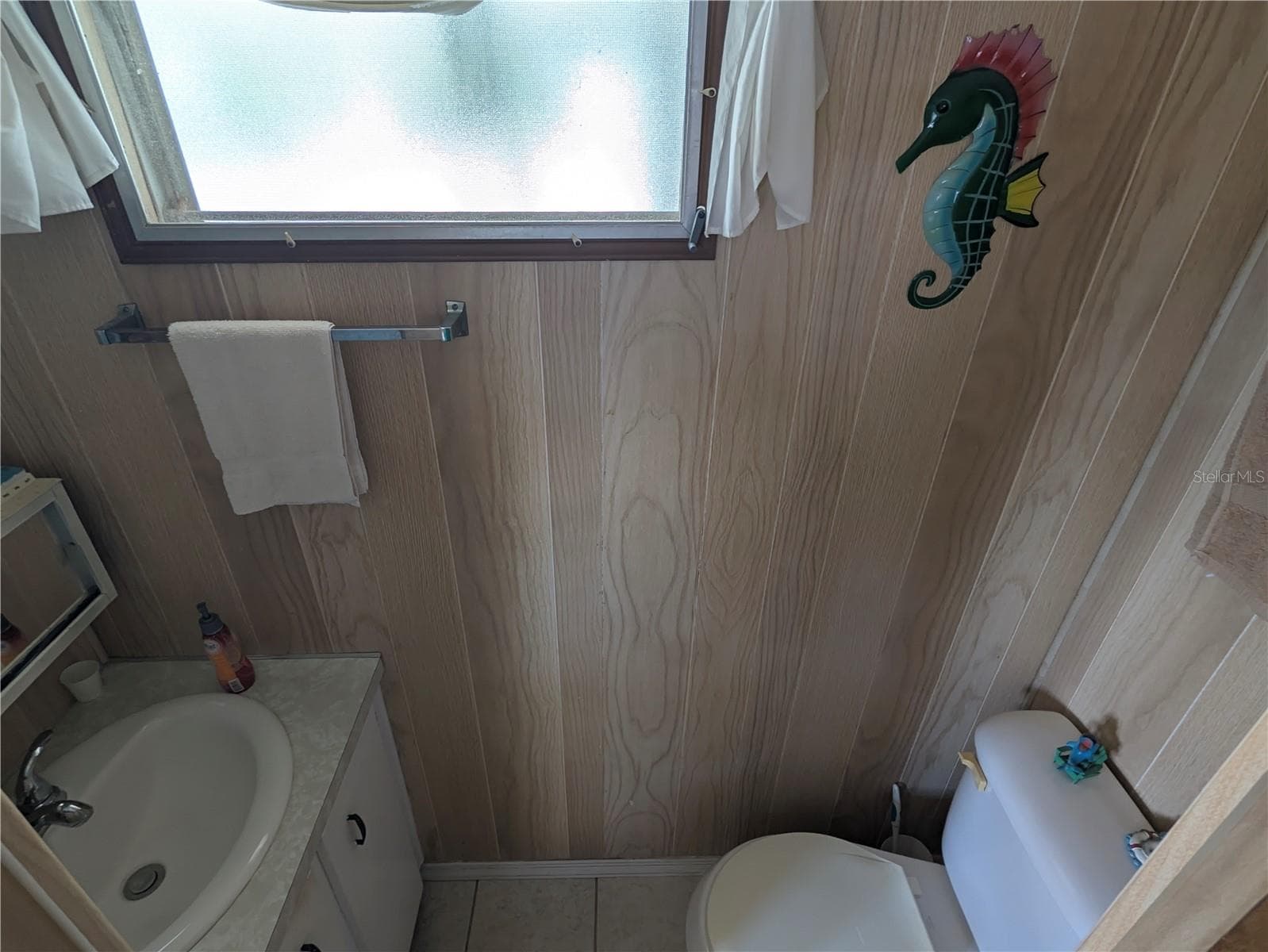 Half bath inside of second bedroom - 34517 ROSE DR N, PINELLAS PARK