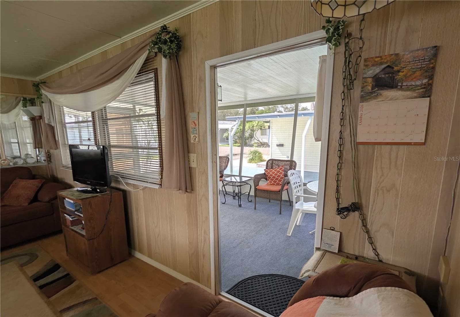 livingroom opening not the screen room. - 34517 ROSE DR N, PINELLAS PARK