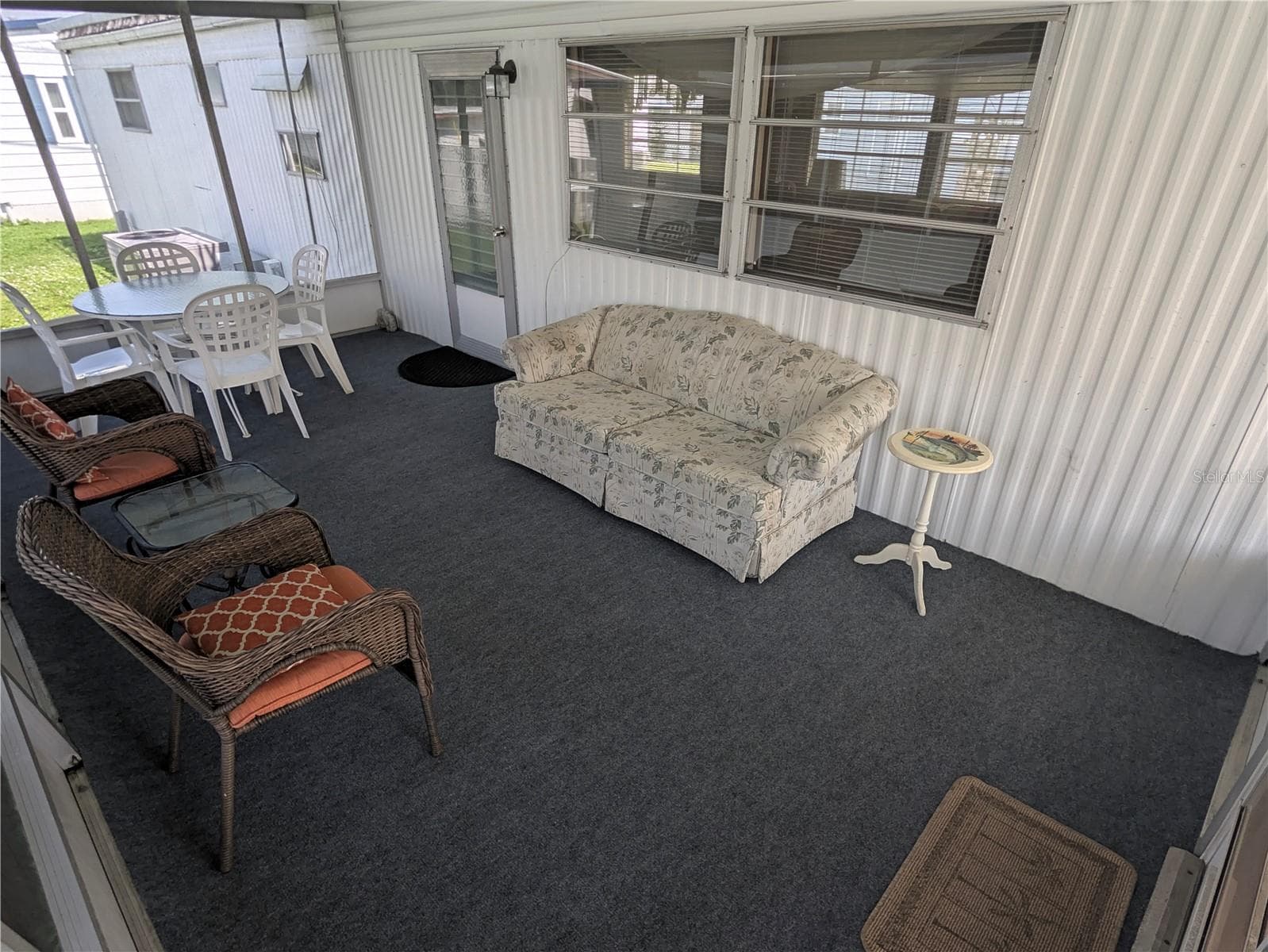 Screen room with new outdoor carpet - 34517 ROSE DR N, PINELLAS PARK