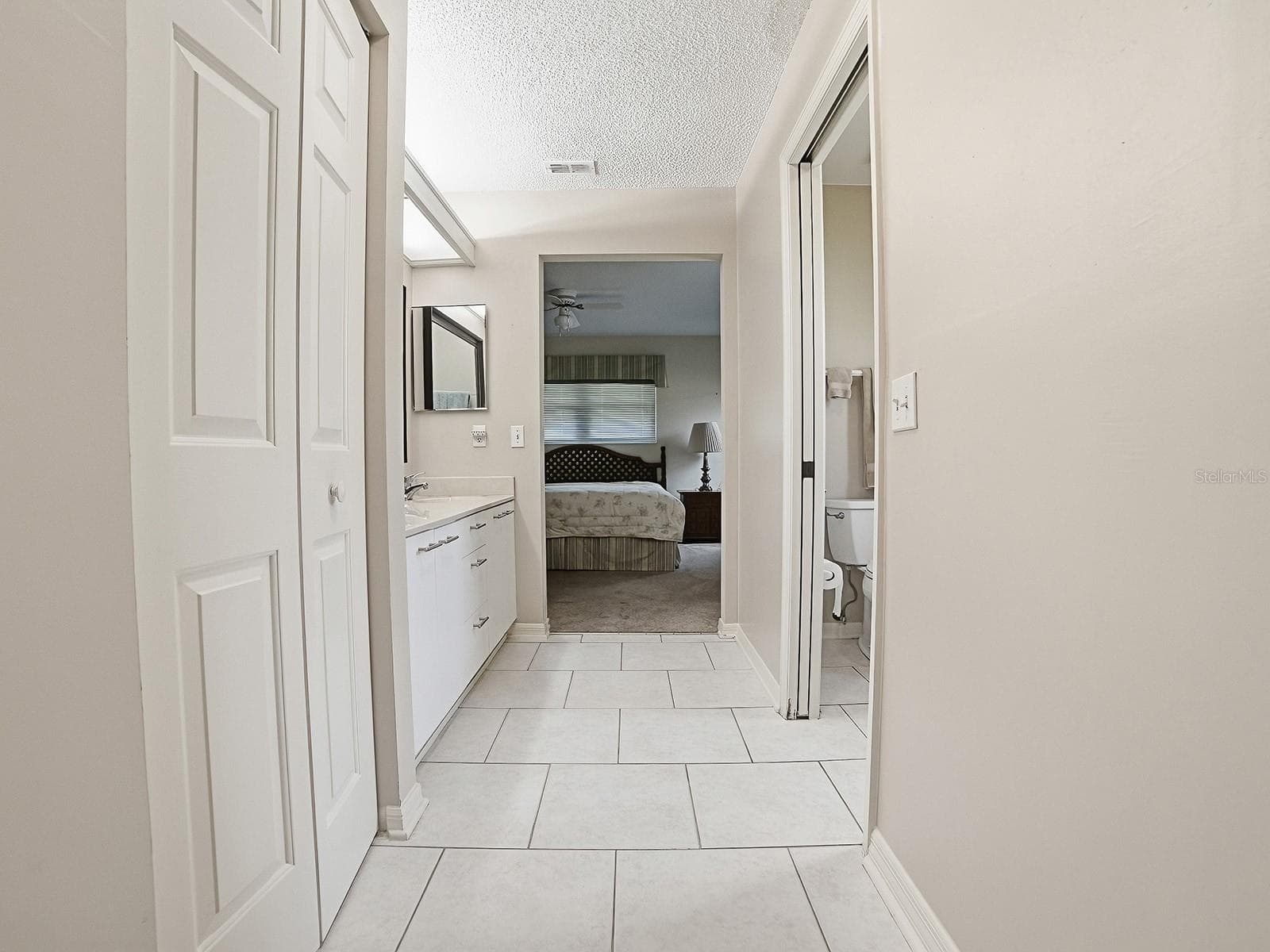 VIEW FROM PRIMARY BEDROOM THROUGH BATHROOM AND TO THE CRAFT/OFFICE/LAUNDRY AREA - 32543 OAK PARK DR, LEESBURG