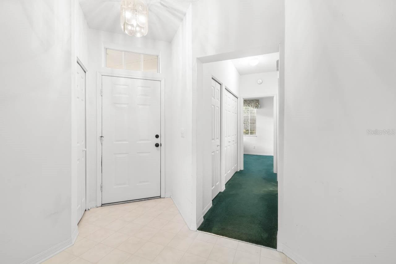 Entry way from inside the front door and view of hallway to guest bath and guest bedroom - 2617 NEWCOMB CT, SUN CITY CENTER